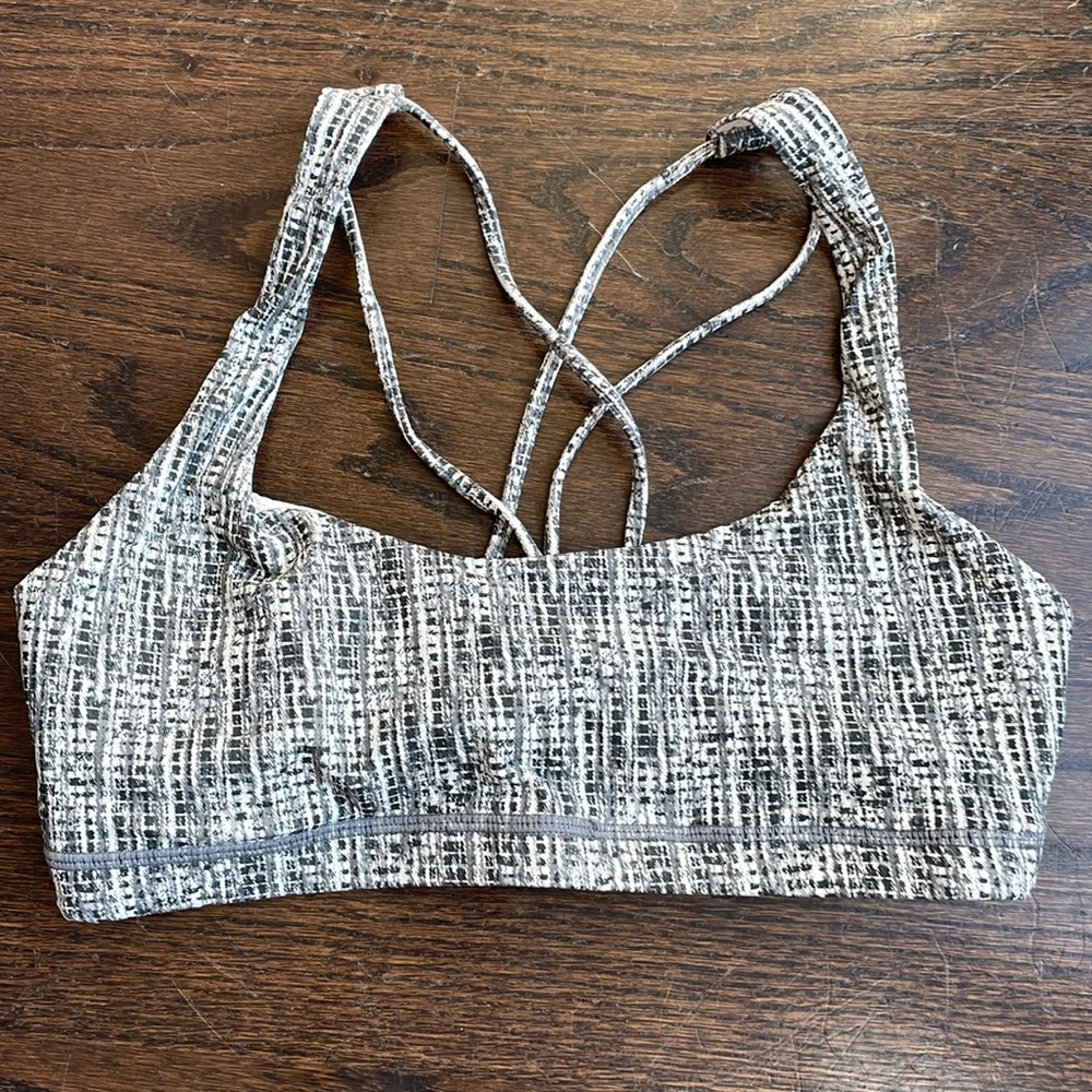 Gently used dark green patterned sports bra, small.